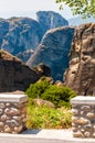 Stone masonry fence on the cliff with scenic landscape view on Meteora rock formations cliffs in Greece