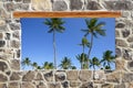 Stone masonry wall window tropical palm trees view Royalty Free Stock Photo