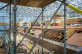 Stone Masons and roofers at work on major roof renovation of historic building at Dyrham Park, Gloucestershire, UK