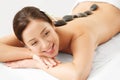 Stone Massage. Beautiful Woman Getting Spa Hot Stones Massage Royalty Free Stock Photo