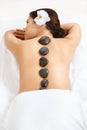 Stone Massage. Beautiful Woman Getting Spa Hot Stones Massage in Royalty Free Stock Photo