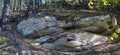 The stone massif of the rock sticks out on the slope of the forest in the Northern taiga. Royalty Free Stock Photo