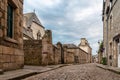 Stone medieval houses in cobblestoned street in Dinan