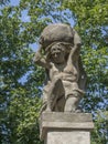 Stone men figure carrying stone, baroque statue from Greek mythology of Sisyphus or Sisyphos