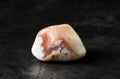 The stone is a mineral on a black concrete background. The concept of using minerals and crystals in astrology and