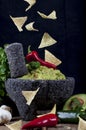 Stone Molcajete with Guacamole and Falling Chips Royalty Free Stock Photo