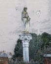 Stone monument and image of Saint on the street in Venice. Street scene, private yard, publick park. Royalty Free Stock Photo