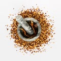 Stone mortar and pestle full of crushed red cayenne pepper, dried chili flakes and seeds isolated on a white background Royalty Free Stock Photo