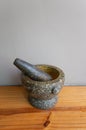 Stone Mortar & Pestle on the wood table gray wall. important tool for making Thai food Royalty Free Stock Photo