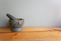 Stone Mortar & Pestle on a wood table gray wall. important tool for making Thai food Royalty Free Stock Photo