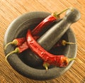 Stone mortar with red chillies Royalty Free Stock Photo