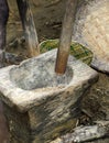 Stone mortar and wooden pestle for pounding rice Royalty Free Stock Photo