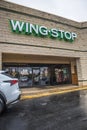 View of a car parked in front of Wing Stop and entrance