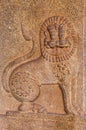 Stone mural sculpture on pillar of Lion on its side at Kadelekalu Ganesha temple, Hampi, Karnataka, India