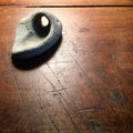 Stone with natural hole on antique wood table.