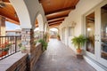 stone path leading to arched double entry beneath balcony