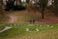 Stone pathway round outdoor prayer labyrinth in a circular shape, Ornamental garden with maze viewed slightly from above. Loucen Royalty Free Stock Photo