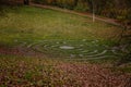 Stone pathway round outdoor prayer labyrinth in a circular shape, Ornamental garden with maze viewed slightly from above. Loucen Royalty Free Stock Photo