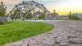 Stone pathway to a dome climbing frame and homes