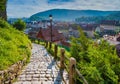 Stone paved alley on hillside of medieval fortified city of Sighisoara, Transylvania region, Romania Royalty Free Stock Photo