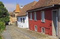 Stone paved old street with colorful houses in Sighisoara fortress Royalty Free Stock Photo