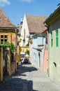 Stone paved old streets with colorful houses in Sighisoara fortress,Transylvania,Romania,Europe...IMAGE Royalty Free Stock Photo