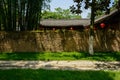 Stone-paved path outside enclosed tile-roofed house in sunny sum Royalty Free Stock Photo