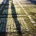 Stone pavement in the sunlight with shadow of man Royalty Free Stock Photo