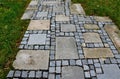 Stone paving with a geomentric pattern, a large rectangular tile lined around a smaller cobblestone paving cube, a pavement in a g