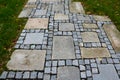 Stone paving with a geomentric pattern, a large rectangular tile lined around a smaller cobblestone paving cube, a pavement in a g Royalty Free Stock Photo