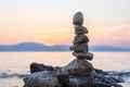 Stone pebble tower on sea shore at sunset. Meditation, zen background, Croatia Royalty Free Stock Photo