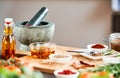 Stone pestle and mortar with herbs and spices Royalty Free Stock Photo