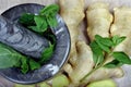 Stone pestle and mortar with mint leaves and ginger on a wooden table. top view. cold and flu remedy. Royalty Free Stock Photo