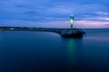 Stone pier in Darlowo in the evening. Lights on the beach. Traffic lights in the port. Blue hour. Poland Royalty Free Stock Photo