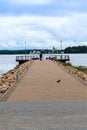 Russia, Valdai, August 2021. A lonely man on the pier that goes into the lake.
