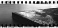 Corner stone pier Sydney Harbour NSW Australia night wide panorama monochrome city lights reflecting on water on surface sprockets