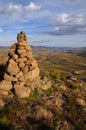 Stone pile on the peak of a mountain in lesotho with a beautiful view over semonkong Royalty Free Stock Photo