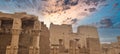 Stone pillars and columns of a grand building set against a backdrop of dramatic clouds Royalty Free Stock Photo