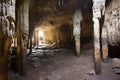 stone pillars inside a cavernous, multi-chambered cave