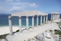 Stone pillars on the top of a cliff overlooking water and white sandy beach Royalty Free Stock Photo