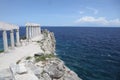 Stone pillars on the top of a cliff overlooking water and white sandy beach Royalty Free Stock Photo