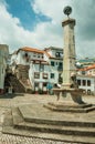 Stone pillory and fountain with old buildings in a square Royalty Free Stock Photo