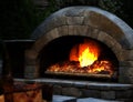 Stone pizza oven and pepperoni pizza close up Royalty Free Stock Photo