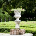 Stone planter with flowers in park
