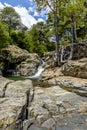 Stone pond with a waterfall of an old forest. Royalty Free Stock Photo