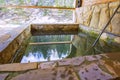 Stone pool outside for cooling after bath in winter Royalty Free Stock Photo