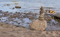 Stone pyramid on the background of river water. The concept of harmony, balance and simplicity Royalty Free Stock Photo