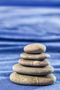 Stone pyramid over blue blurred background Royalty Free Stock Photo