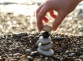 Stone pyramid. Pebbles balance pile, harmony zen stones, balance stack, sea pebble pyramid on shoreline, relaxation