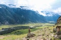 Stone pyramid in river valley Chulyshman. Natural landscape Republic Altai, Russia, summer day. mountain in clouds Royalty Free Stock Photo
